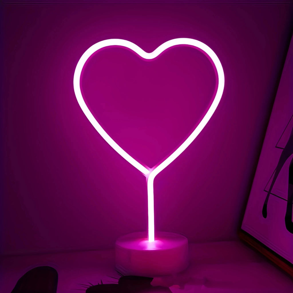 Heart Neon Light glowing pink on a desk